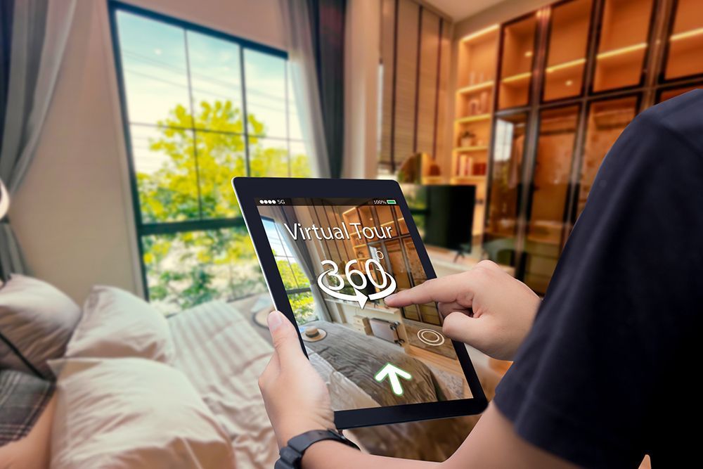 A person is holding a tablet with a 360 degree view of a bedroom.
