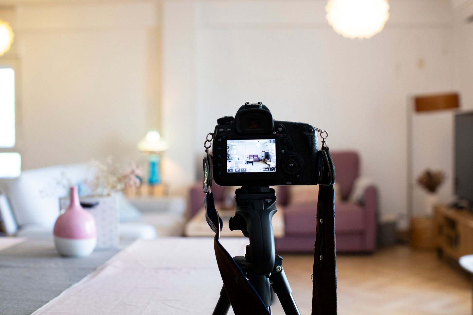 Camera on tripod in living room, used by a photographer in Los Angeles, CA for real estate photos.
