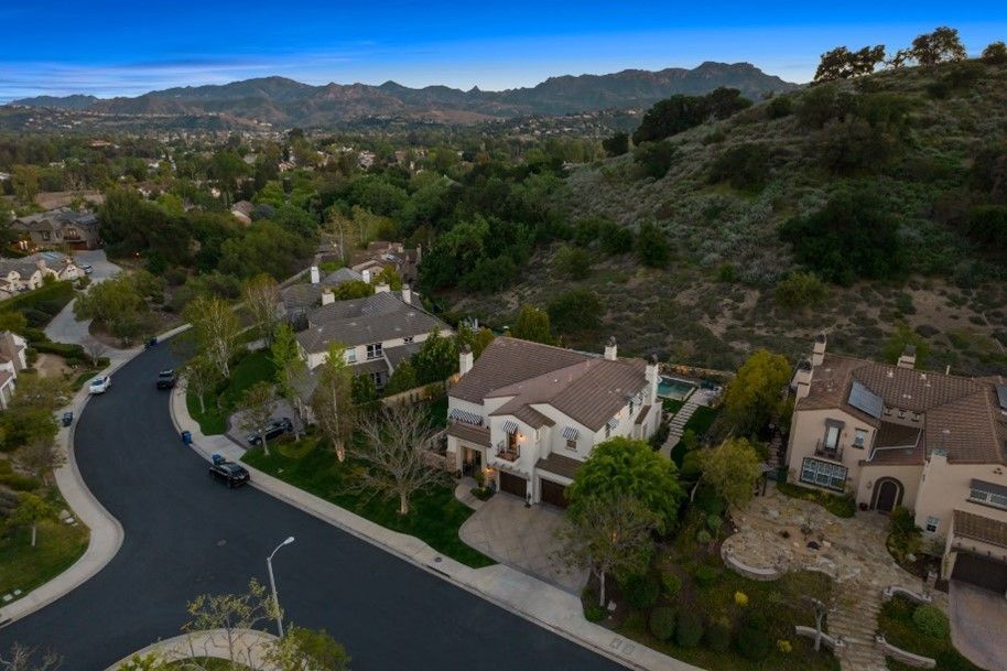An aerial view of a residential neighborhood with mountains in the background