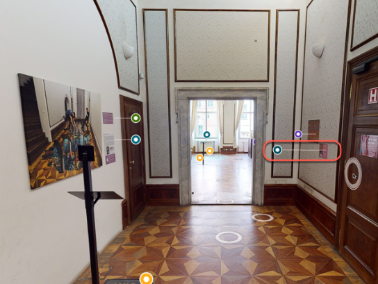 A living room with a black couch and a view of the city