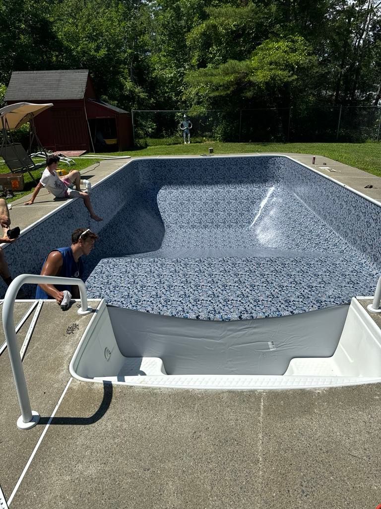 A group of people are working on a swimming pool.