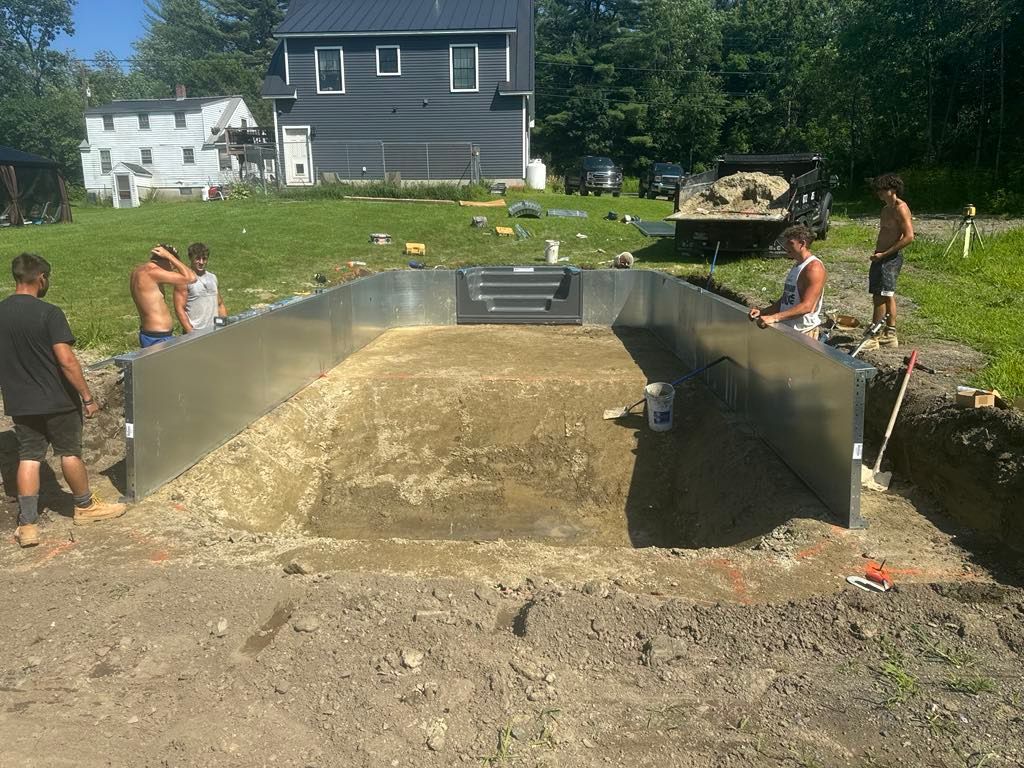 A group of men are working on a swimming pool