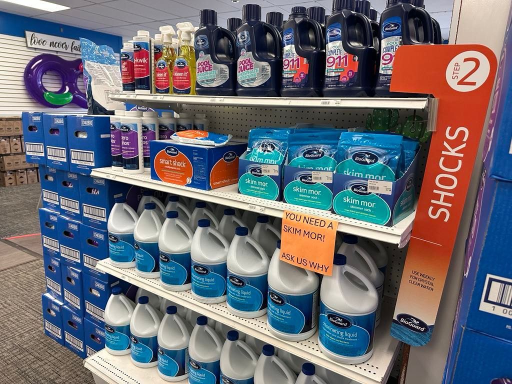 A store shelf filled with lots of bottles of bleach.