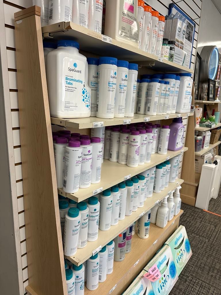 A store shelf filled with lots of bottles of shampoo and conditioner.