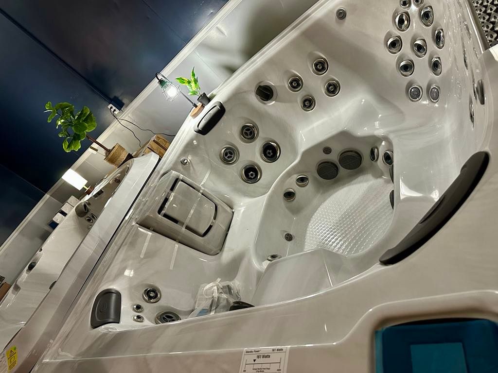 A white hot tub is sitting on top of a table in a room.