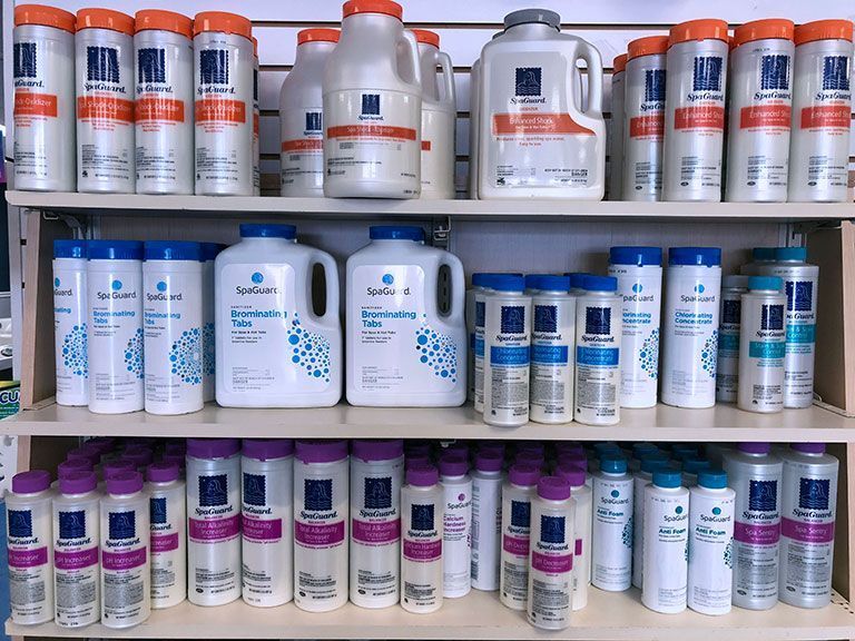 A shelf filled with bottles of shampoo and conditioner