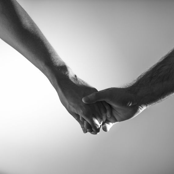 Two hands clasped together, black and white photograph.