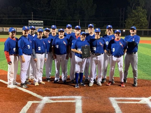 Baseball player sliding into home plate, catcher in front. Blue and gold uniforms, action shot.