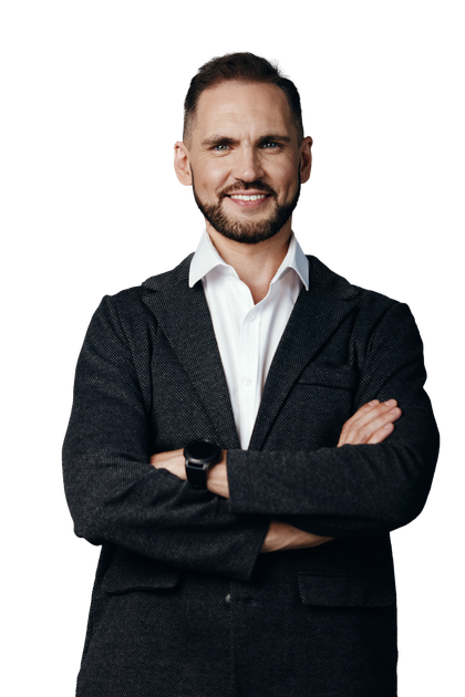Man in a blazer and open-collared white shirt with arms crossed, smiling.