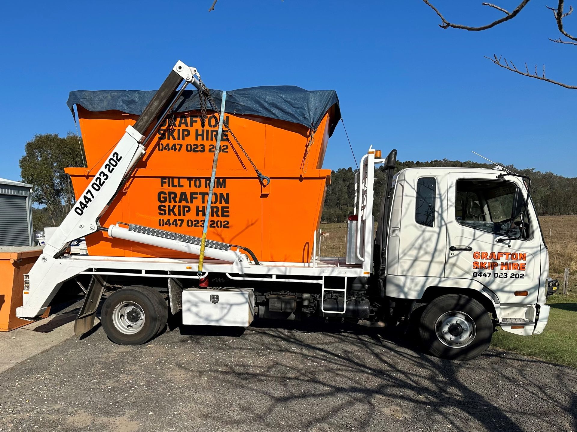 Three Yellow Dumpsters Are Parked in Front of a Building — Grafton Skip Hire–Zims Bins in South Grafton, NSW