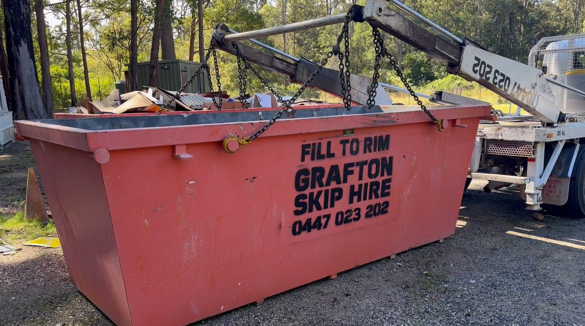 A Blue Dumpster is Sitting in Front of a House Under Construction — Grafton Skip Hire–Zims Bins in South Grafton, NSW