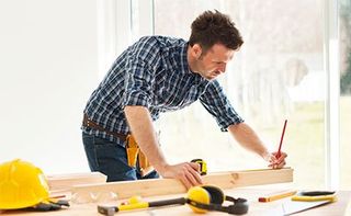 Measuring Wooden Plank - Building Remodeling & Repair Contractors in Easton, MD