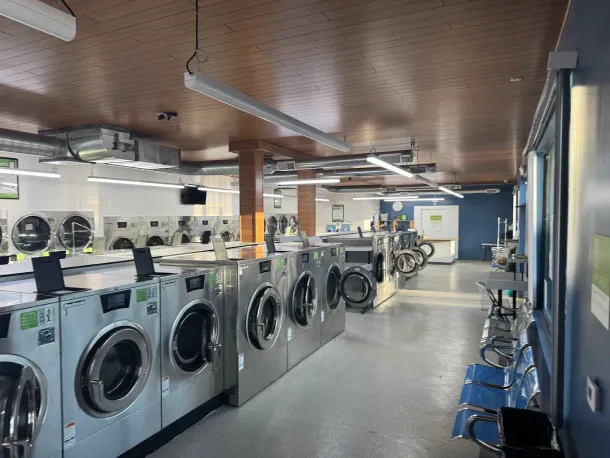 A row of washing machines in a laundromat.