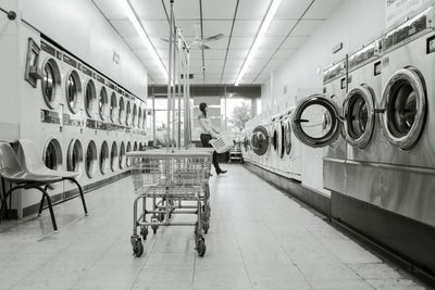Laundromat with lots of washing machines.