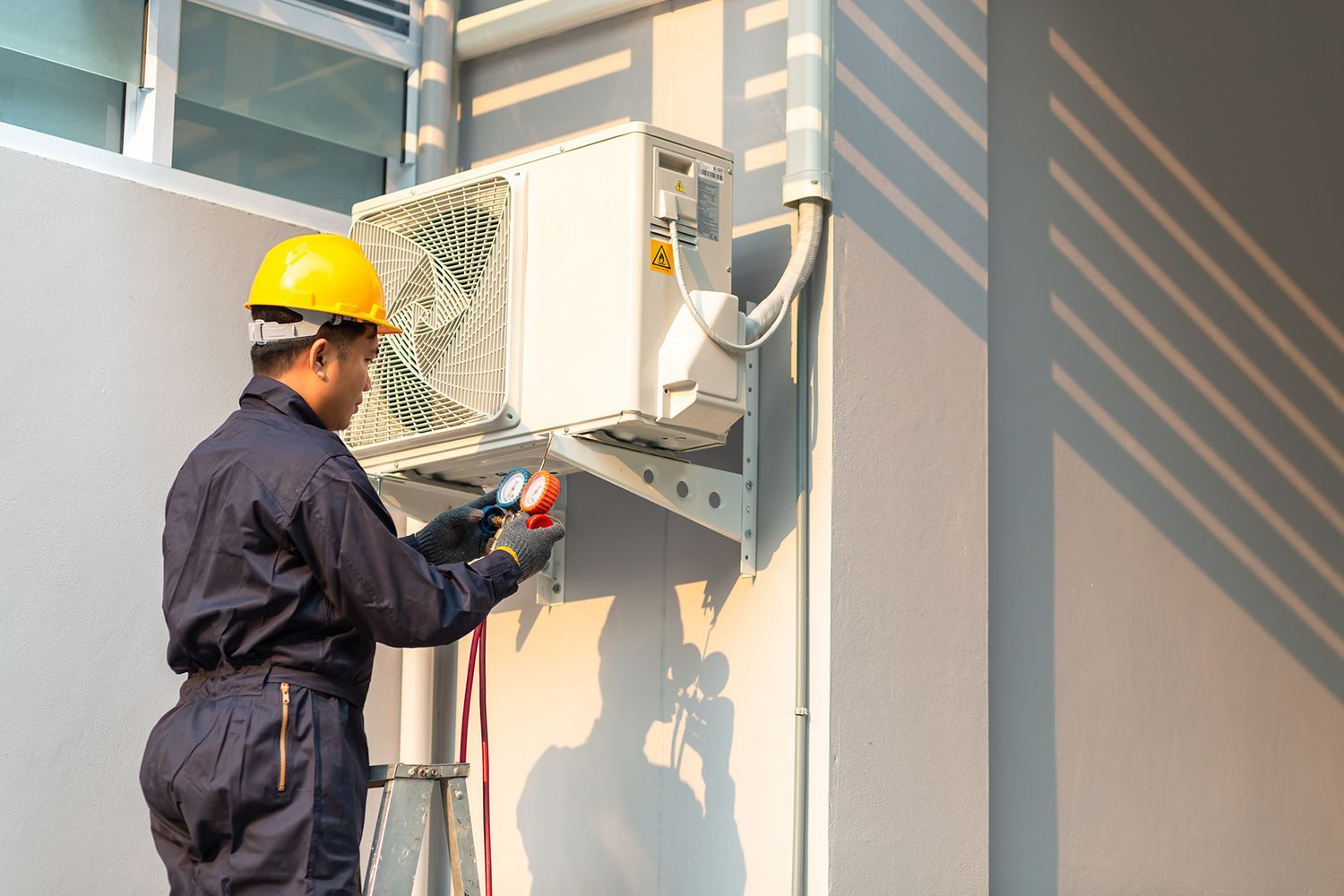 Technician repairing air conditioner.