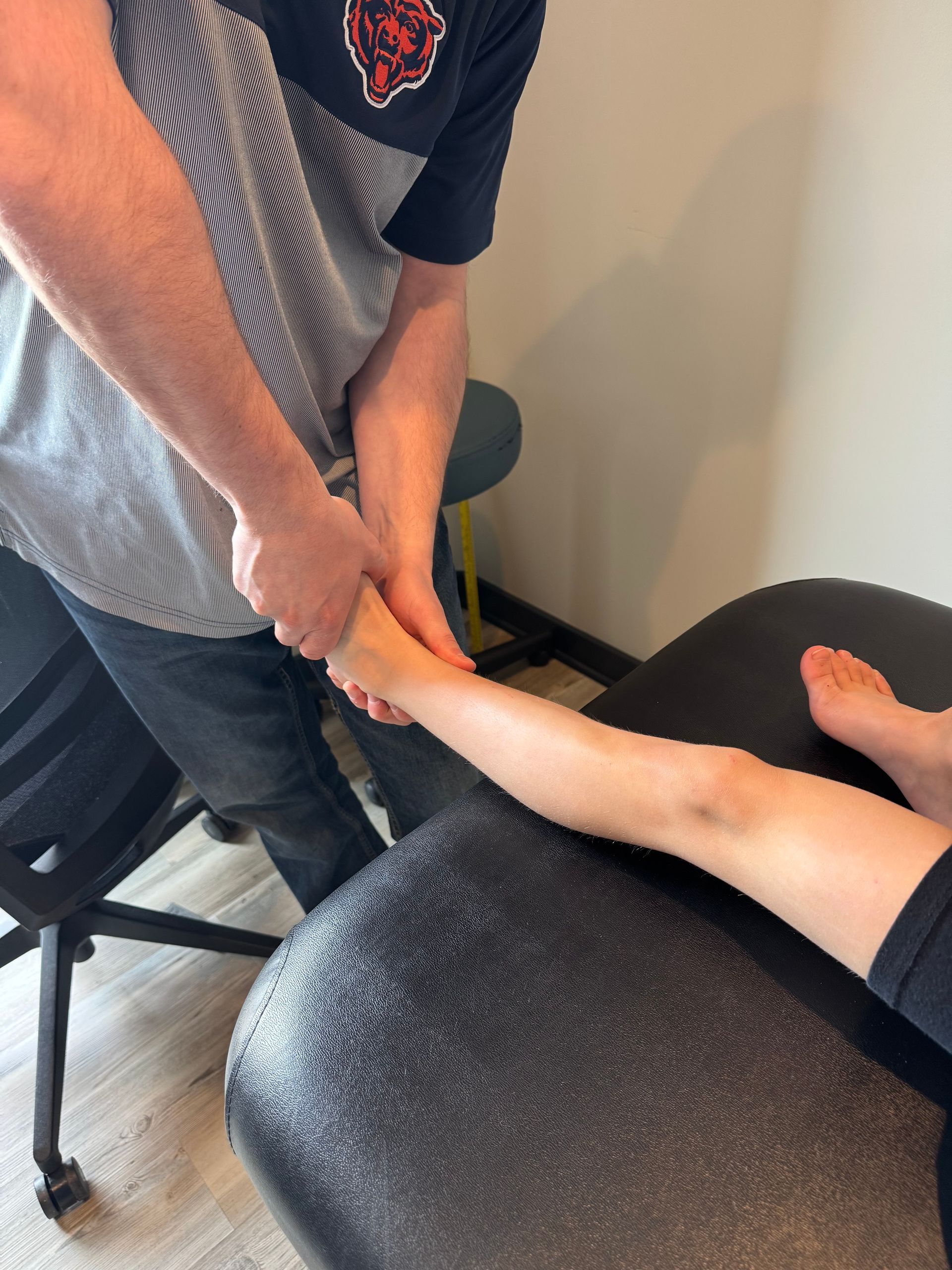 A man is massaging a woman 's foot on a table.