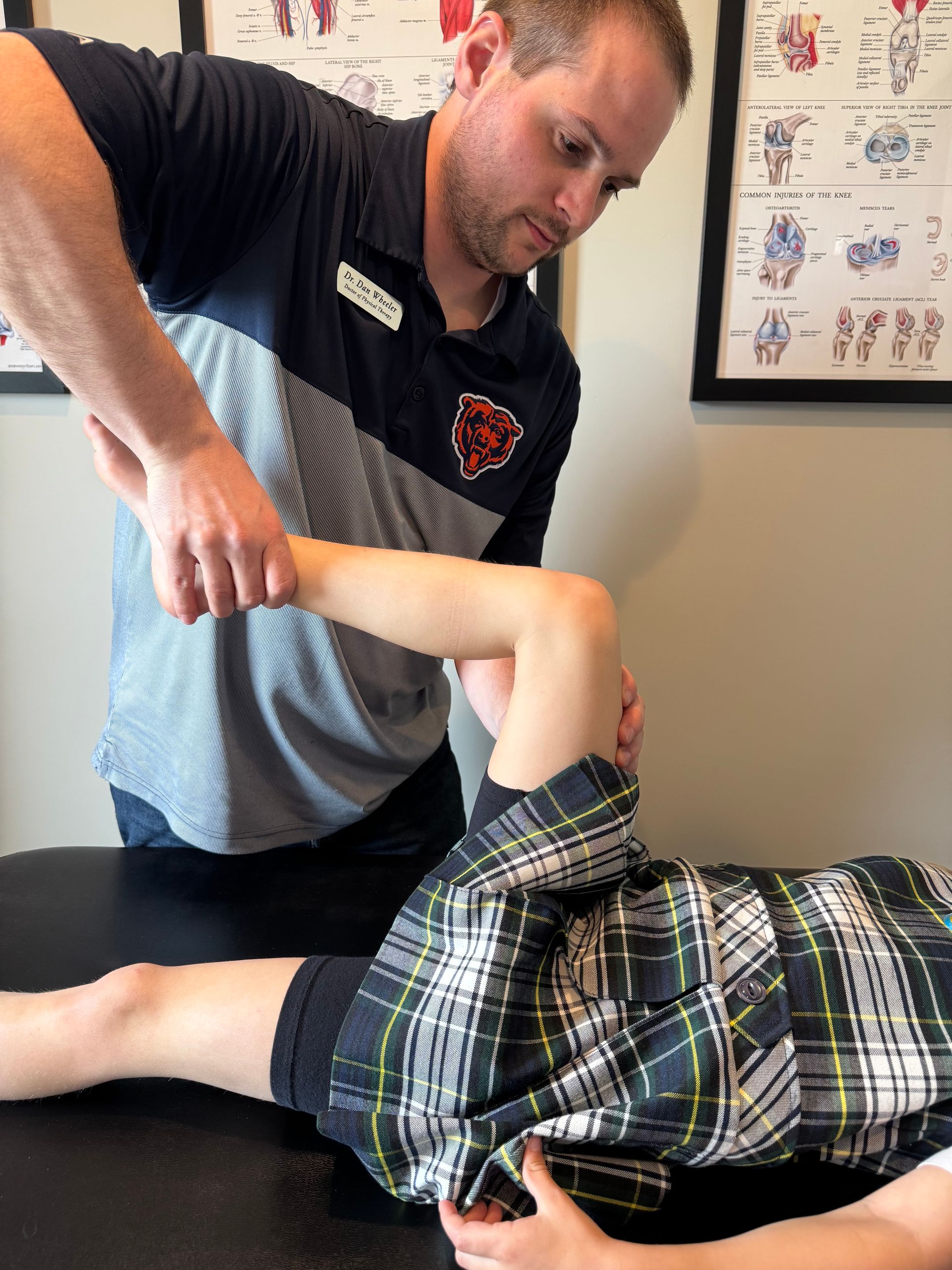 physical therapist stretching a young athlete's leg to help her recover faster