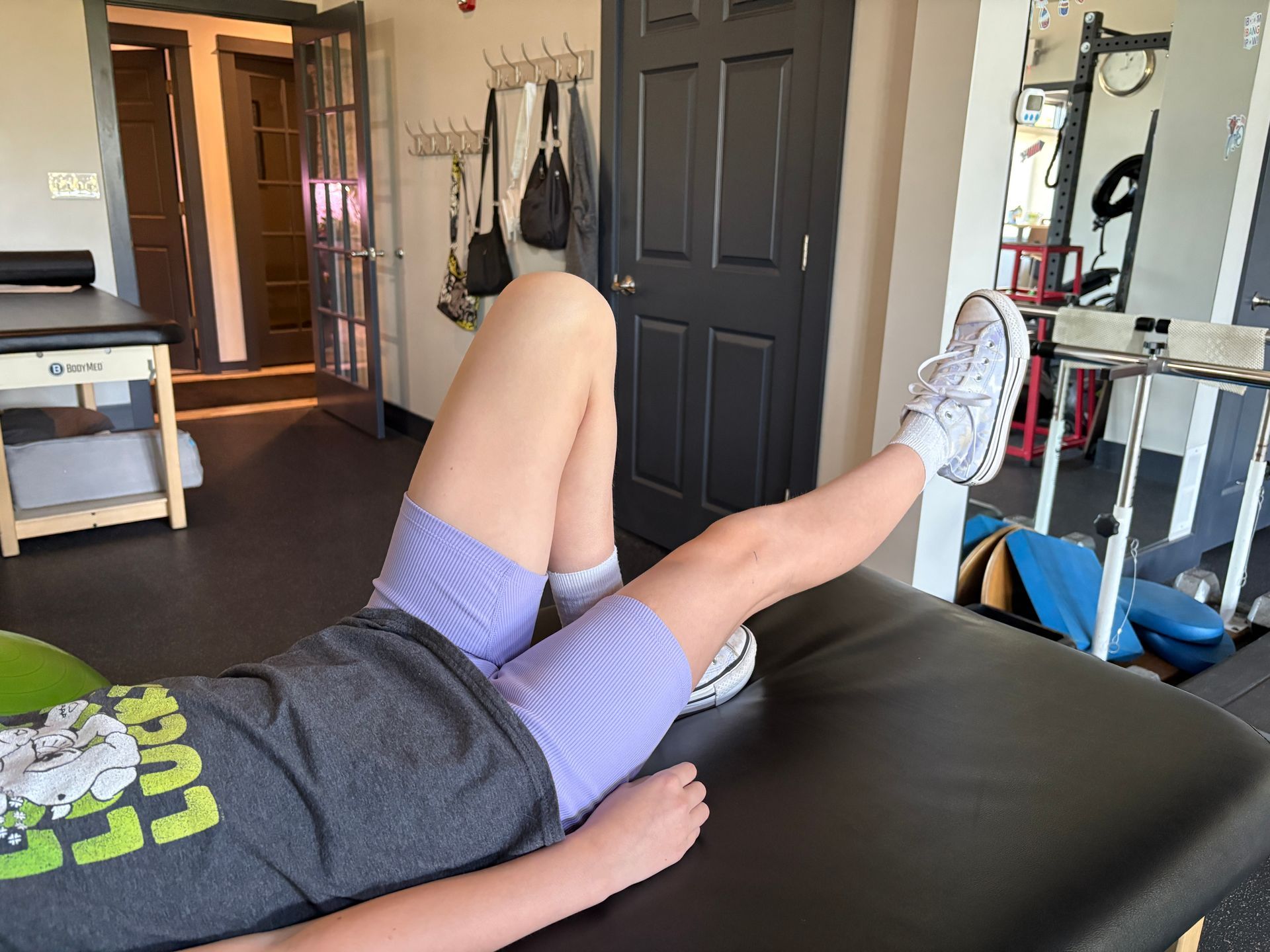 a young female athlete doing a physical therapy stretch to help her recover faser