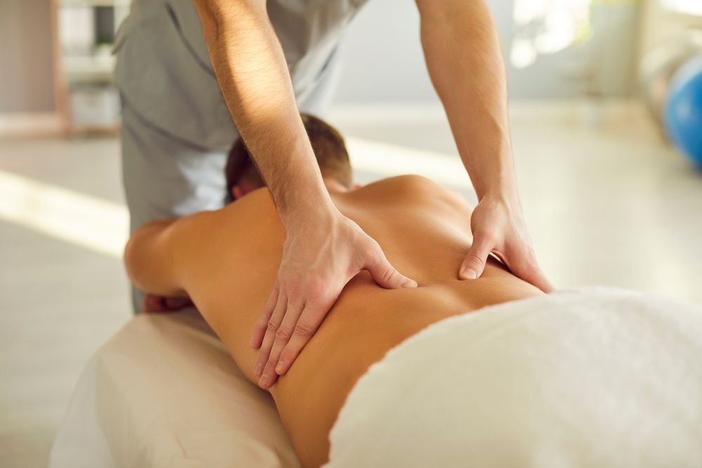 A chiropractor giving massage treatment to a patient.