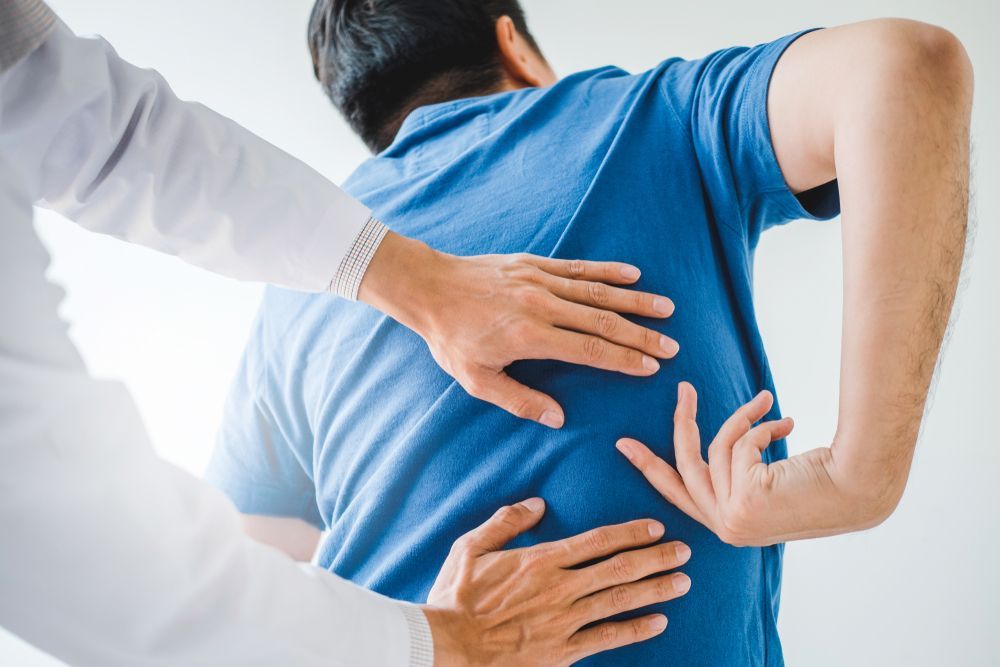 A man is seeing a chiropractor for lower back pain