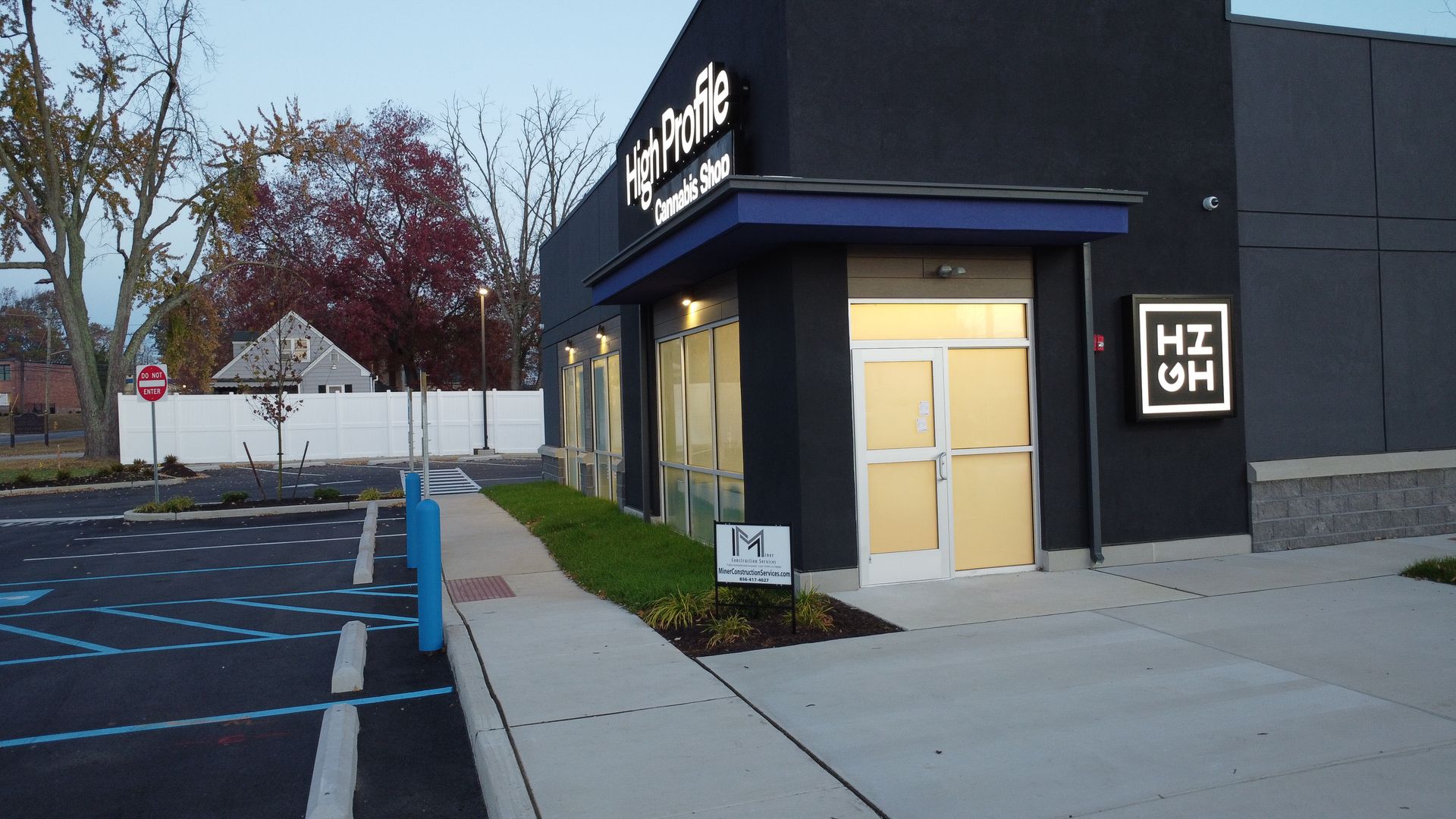 An office with a lot of windows and desks with computers.