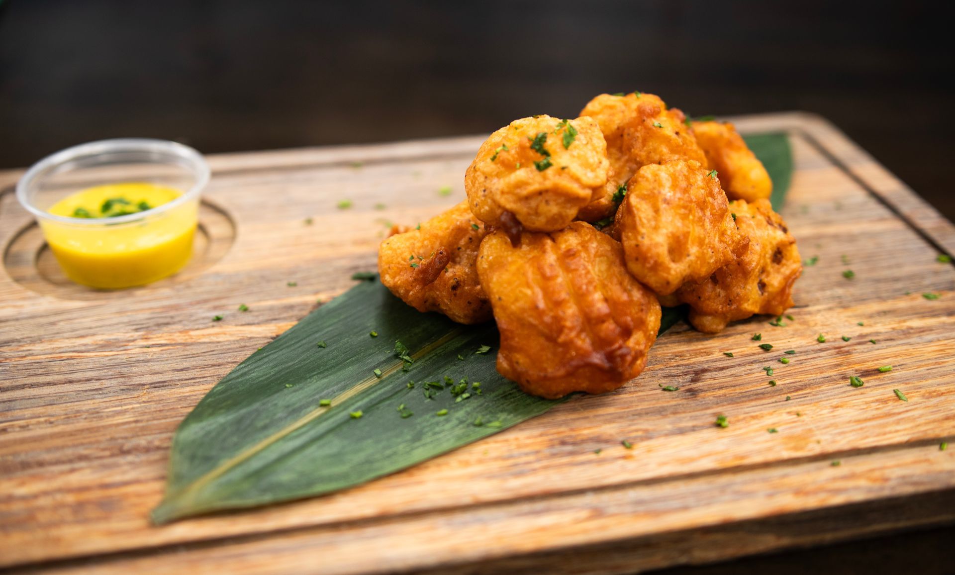 A close up of a plate of food on a wooden cutting board.