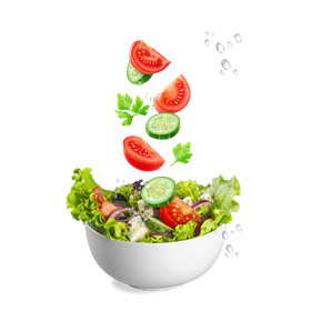 Tomatoes , cucumbers , and parsley are falling into a bowl of salad.