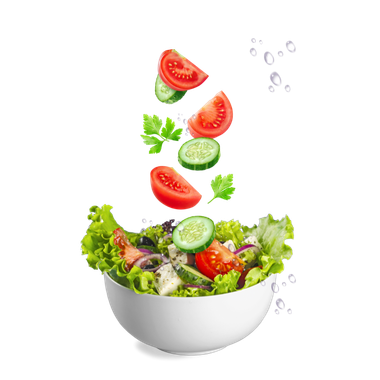 Tomatoes , cucumbers , and parsley are falling into a bowl of salad.