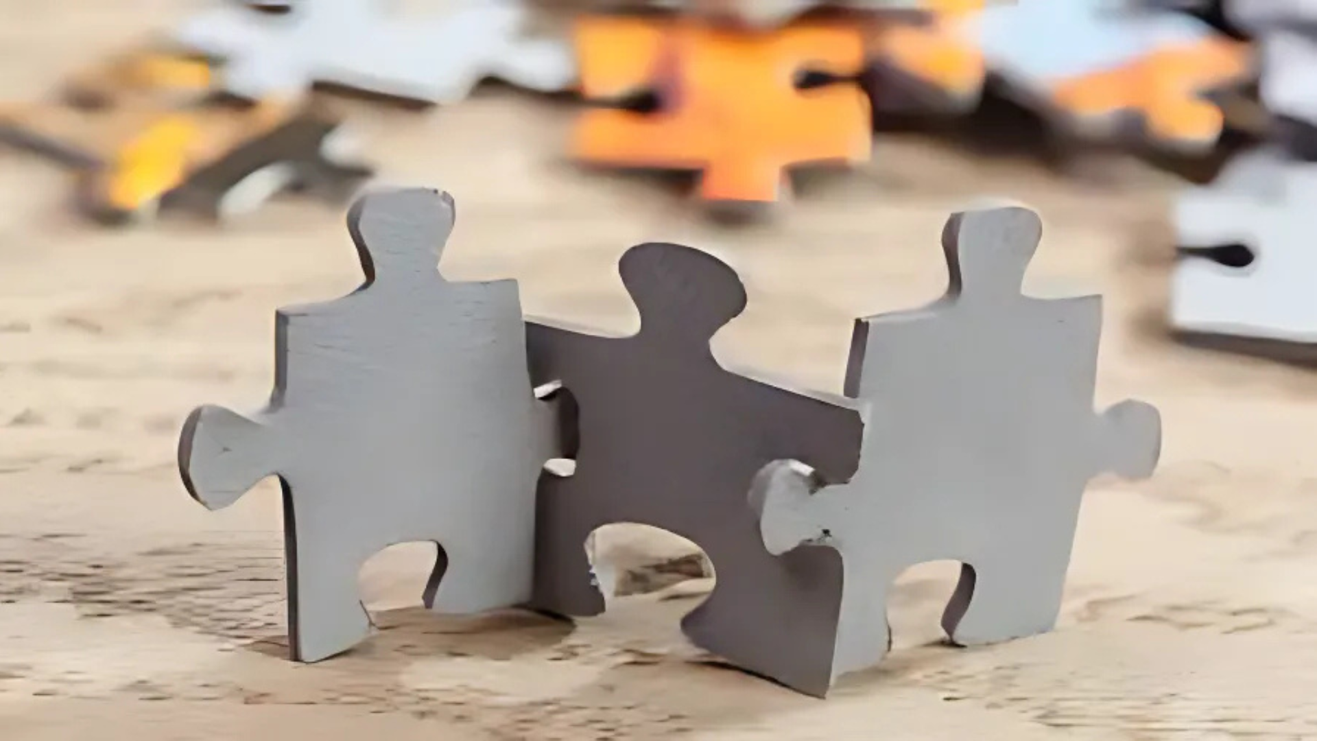 Two puzzle pieces are sitting next to each other on a table.