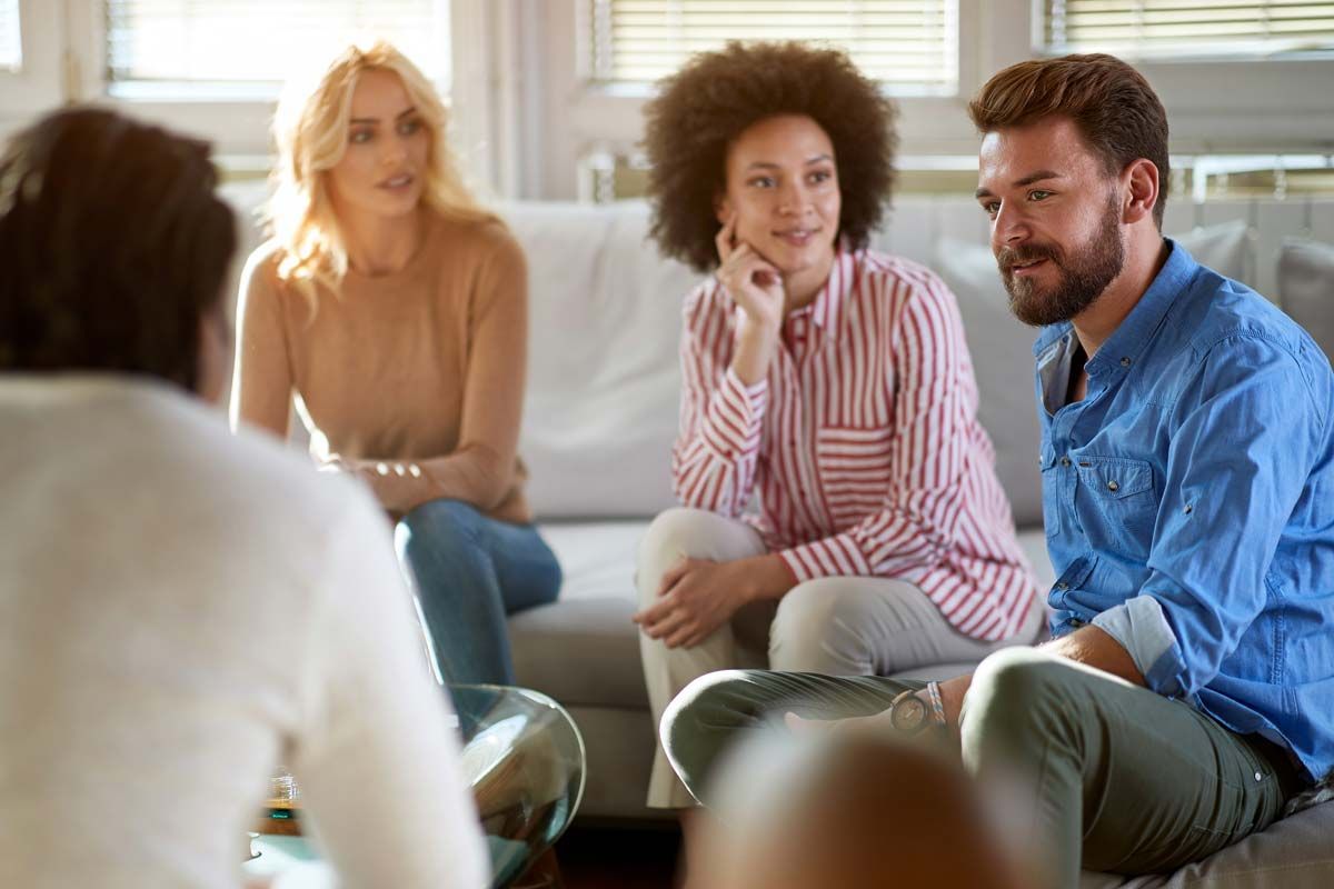 A group of clients in a substance use treatment session.