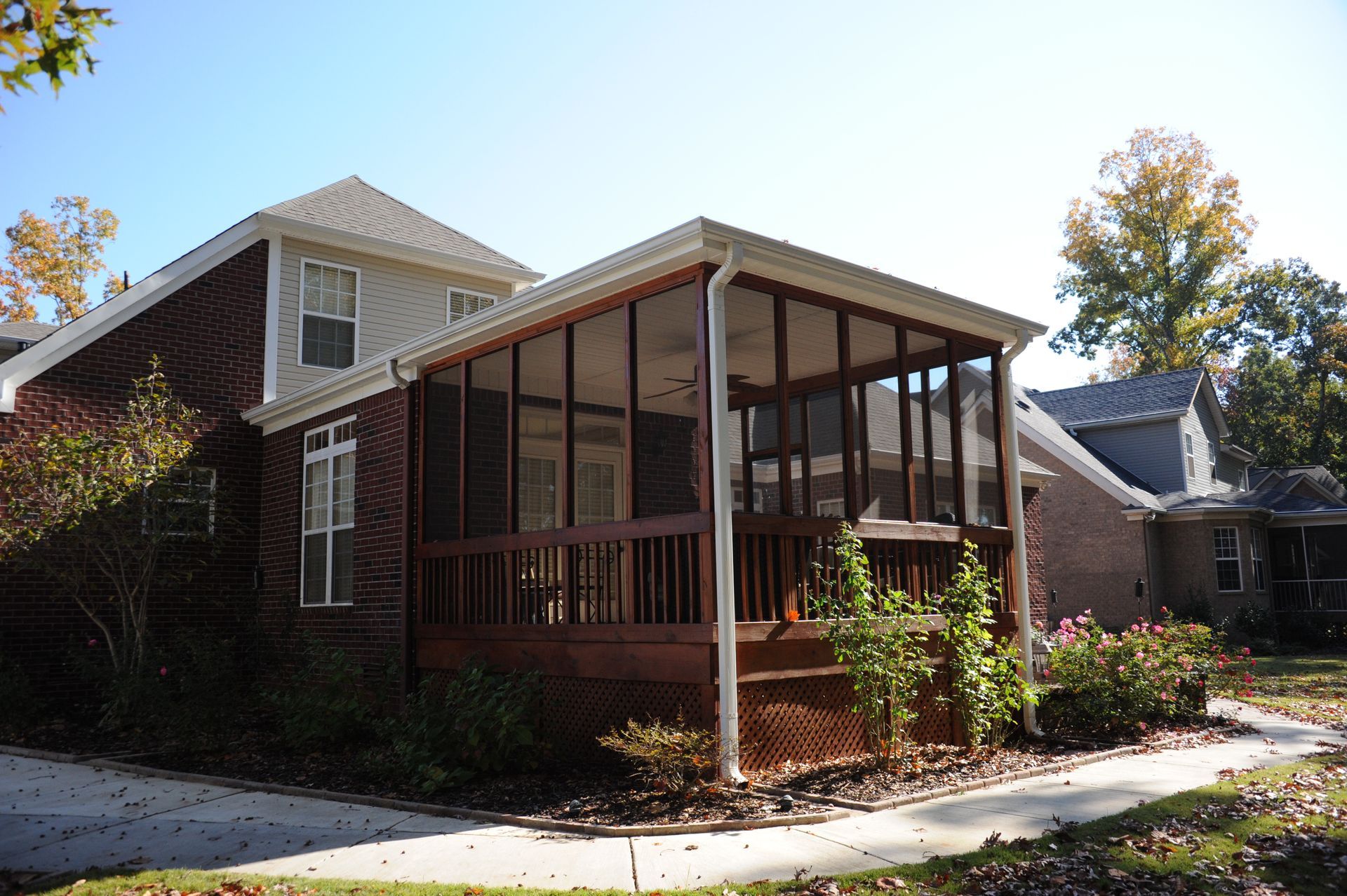 A house with a screened in porch in front of it