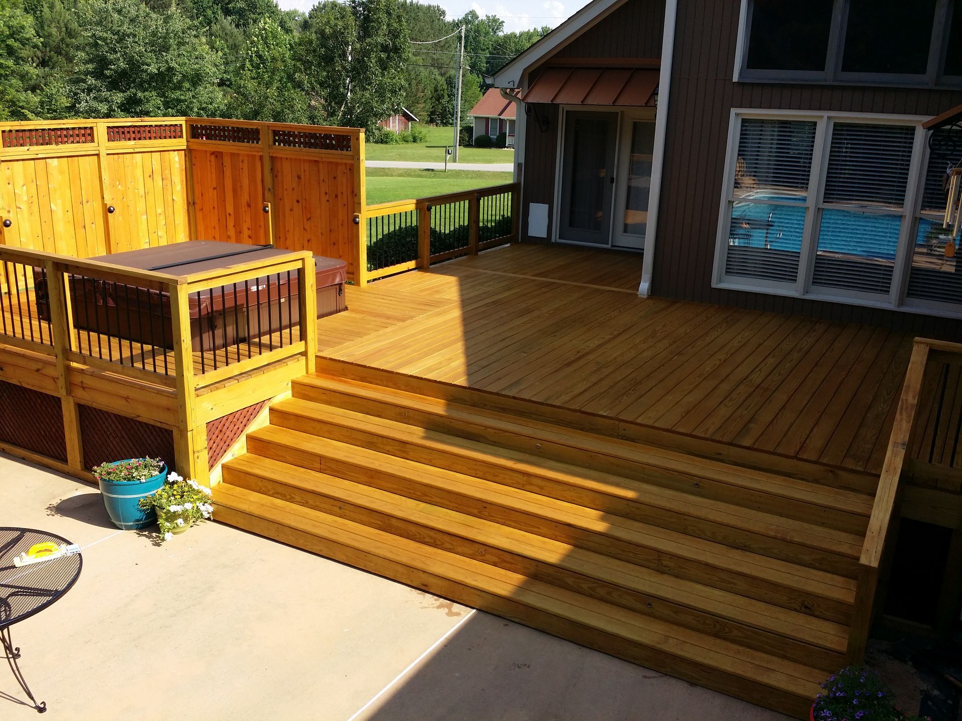 A wooden deck with stairs and a hot tub on it