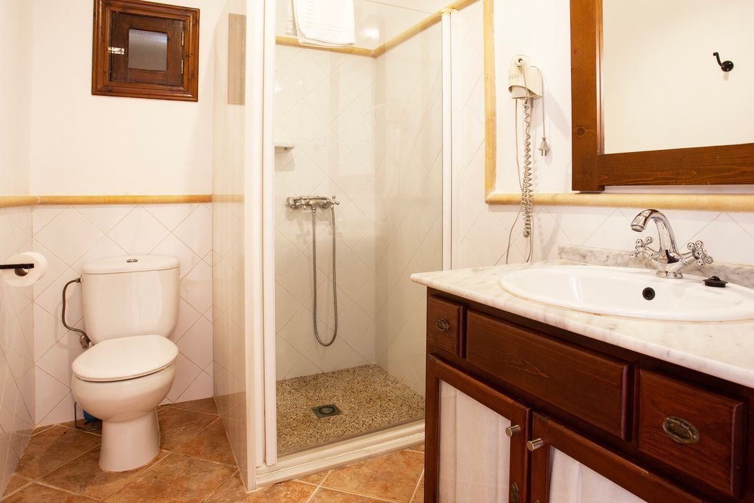 Ein Badezimmer mit Toilette, Waschbecken und Dusche.