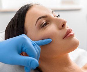 Plastic Surgery — Surgeon Examining A Patient's Face in Orlando, FL