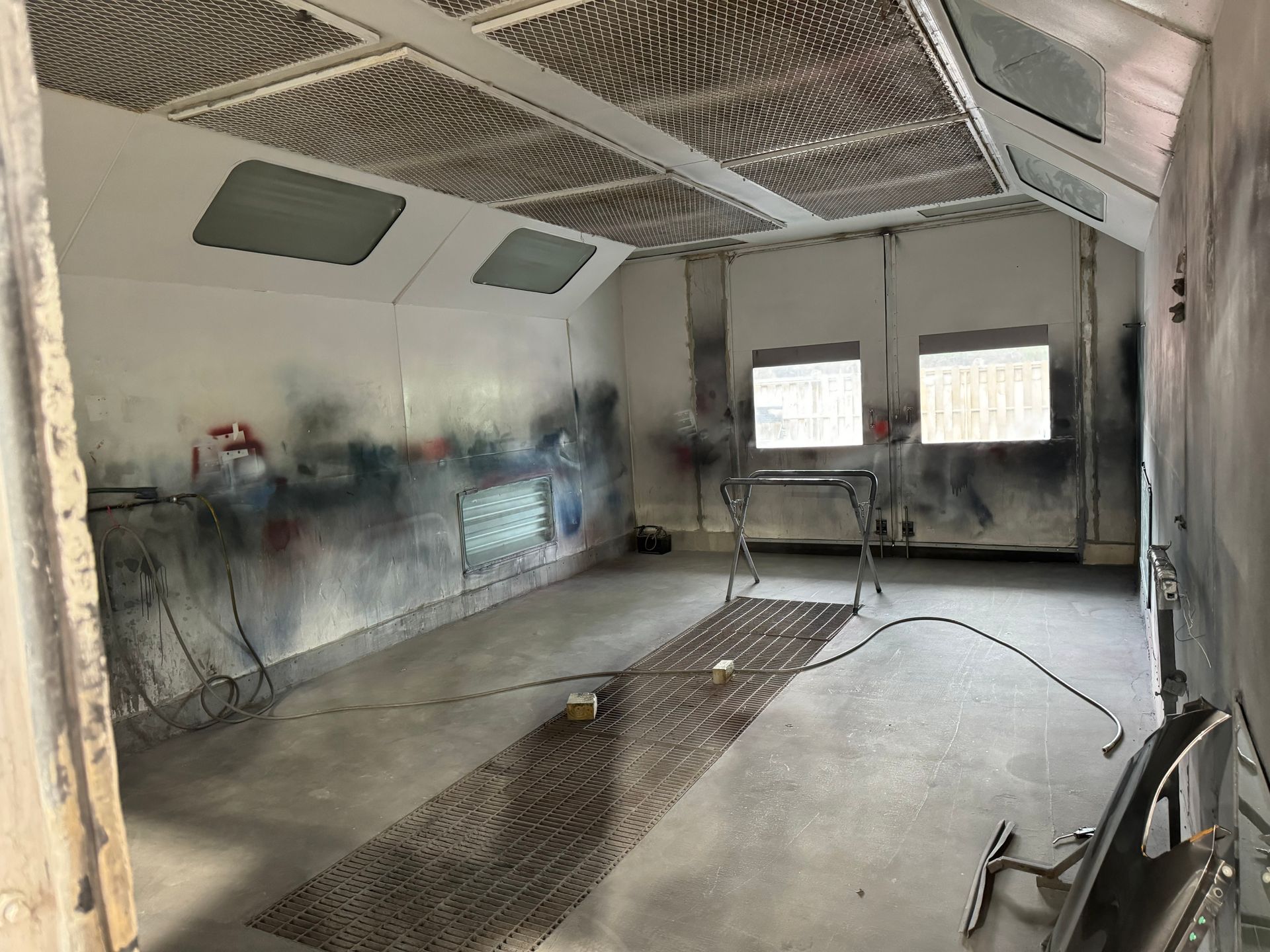 A person is using a tool to fix a dent on a car.