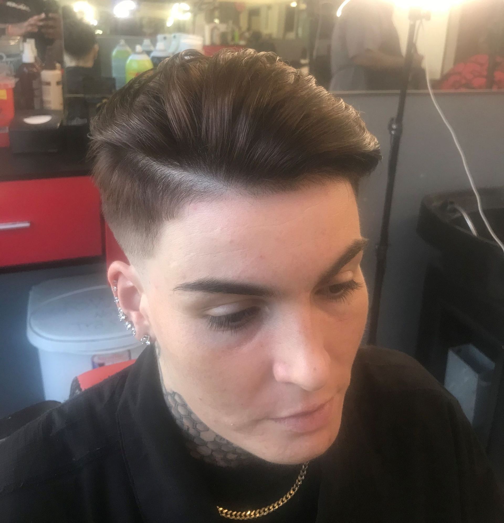 A close up of a woman 's face with a tattoo on her neck