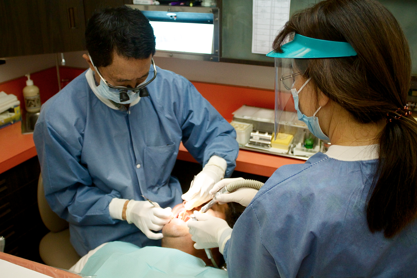 Dentists performing a check-up on a patient