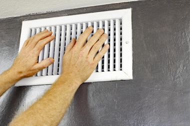 man holding the vent cover