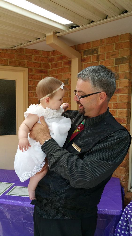 Man Holding A Baby — Celebrant in Hallidays Point, NSW