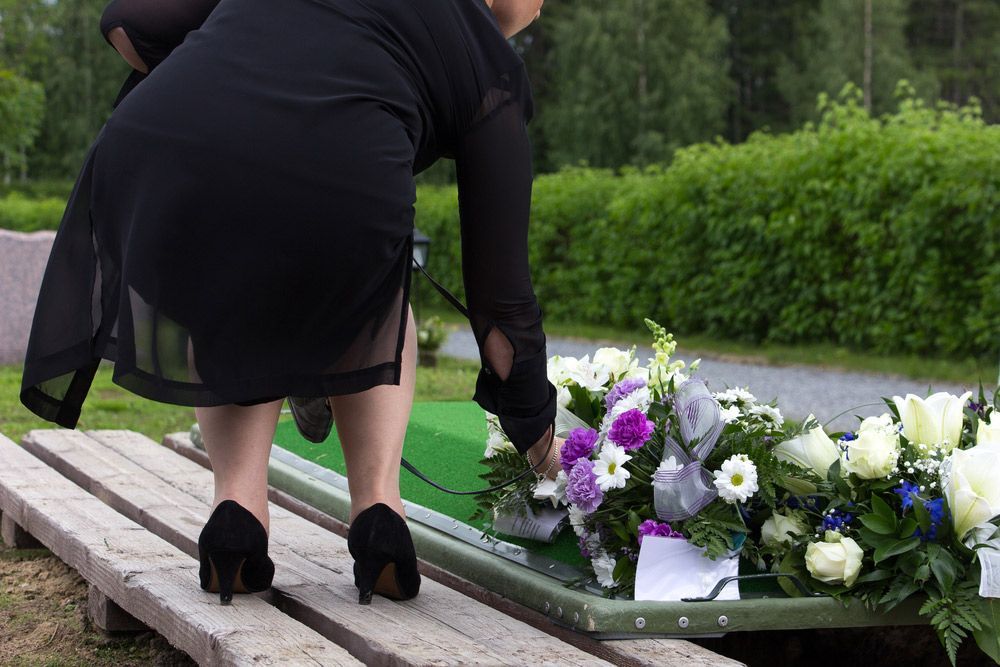 Lady Putting Flowers On  Funeral — Celebrant in Hallidays Point, NSW