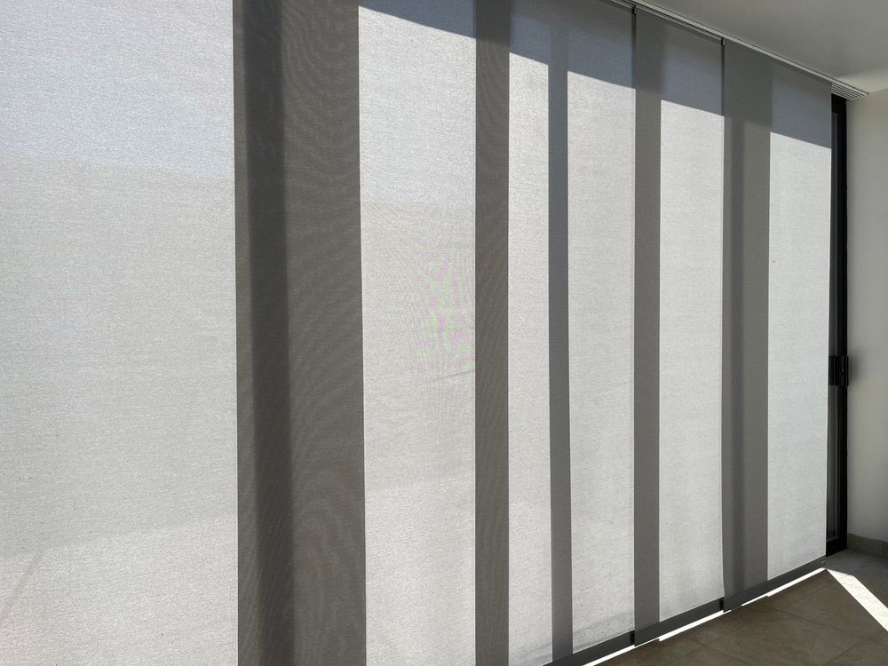 A Row Of Vertical Blinds On A Sliding Glass Door — Window Coverings in Gold Coast, QLD