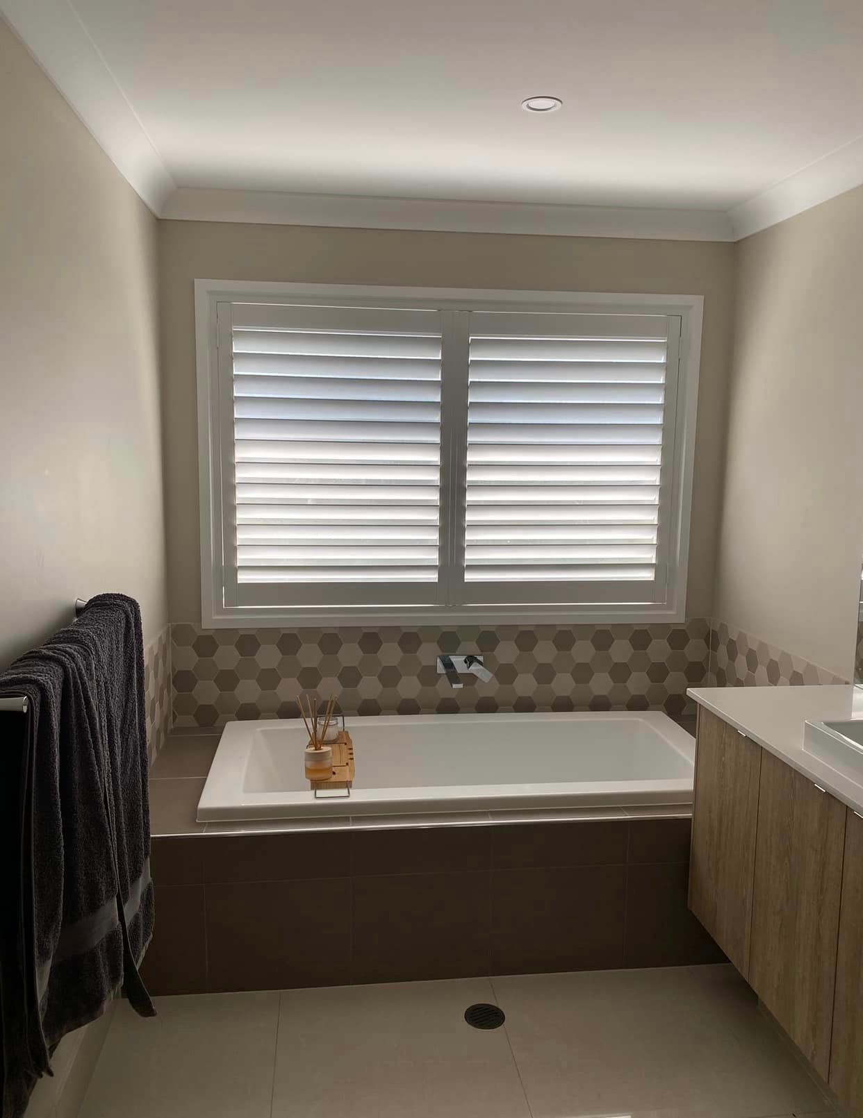 Bathroom Tranquility: Bathtub Views Through Elegant Shutters — Window Coverings in Gold Coast, QLD