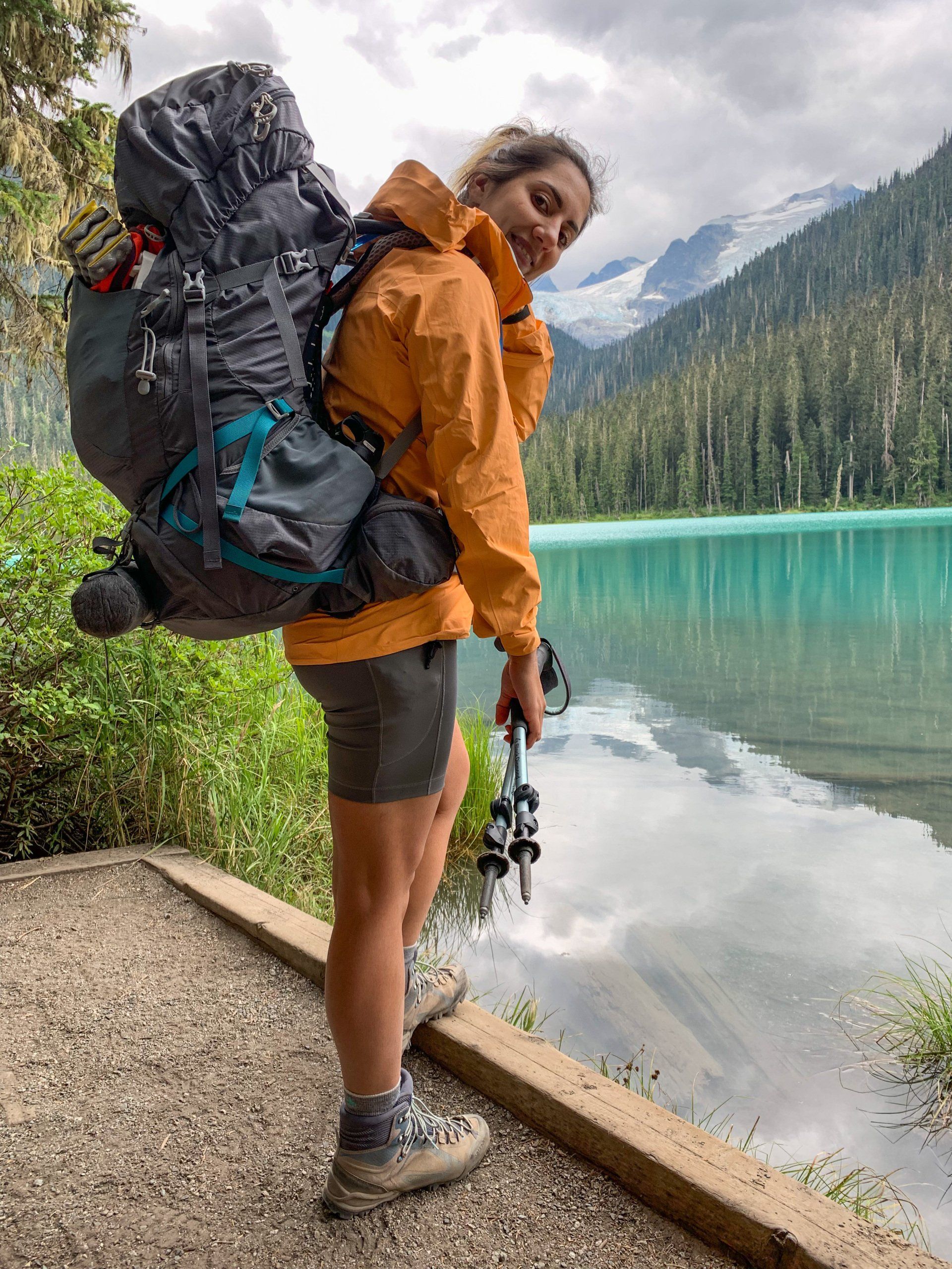 Lower Joffre lake and a female backpacker with pack full of gear, Joffre Lakes Provincial Park, BC, Canada