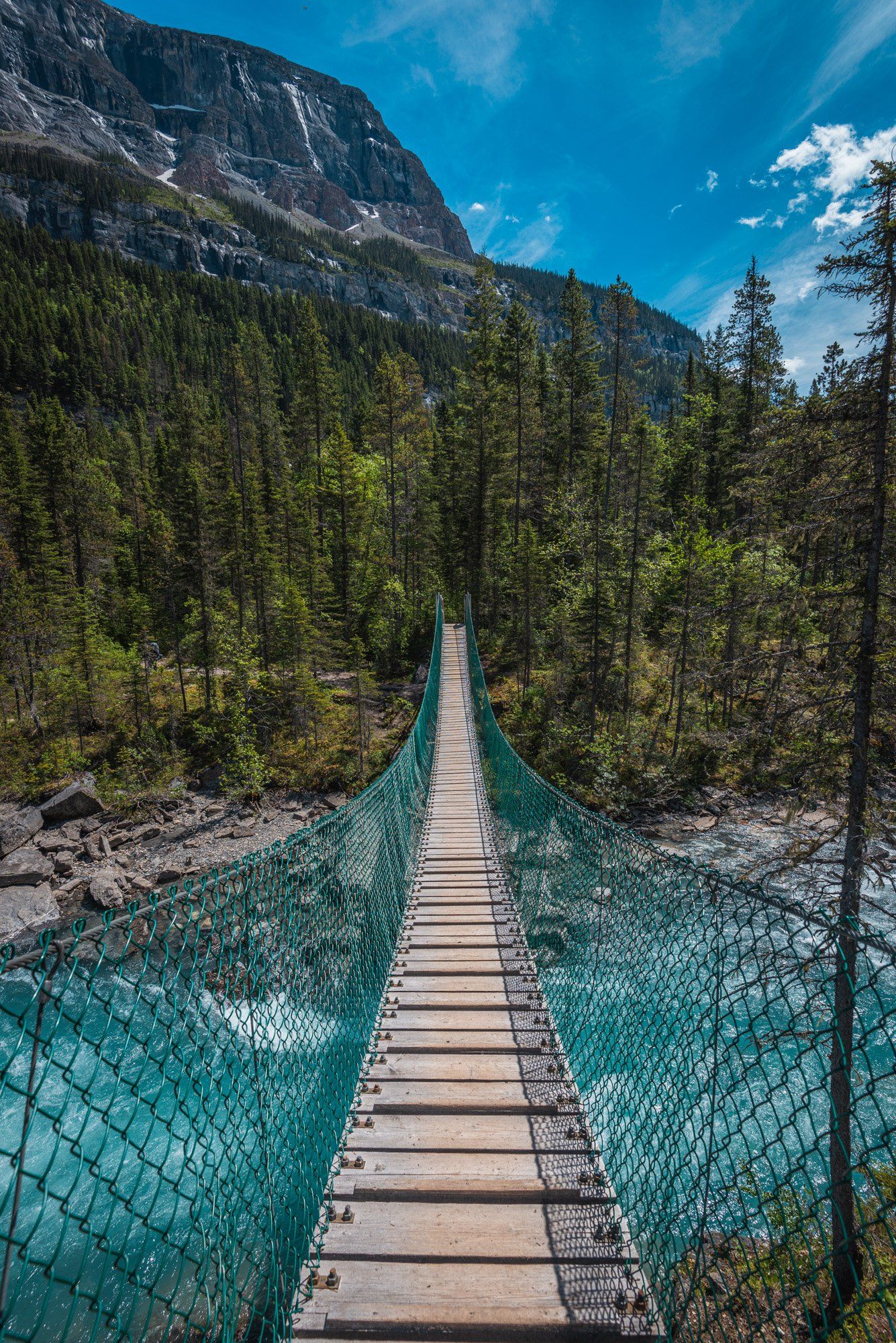 Bridge near the Whitehorn camp, mt Robson park, BC, Canada. Turquoise lake and mountains touched with first rays of morning sun