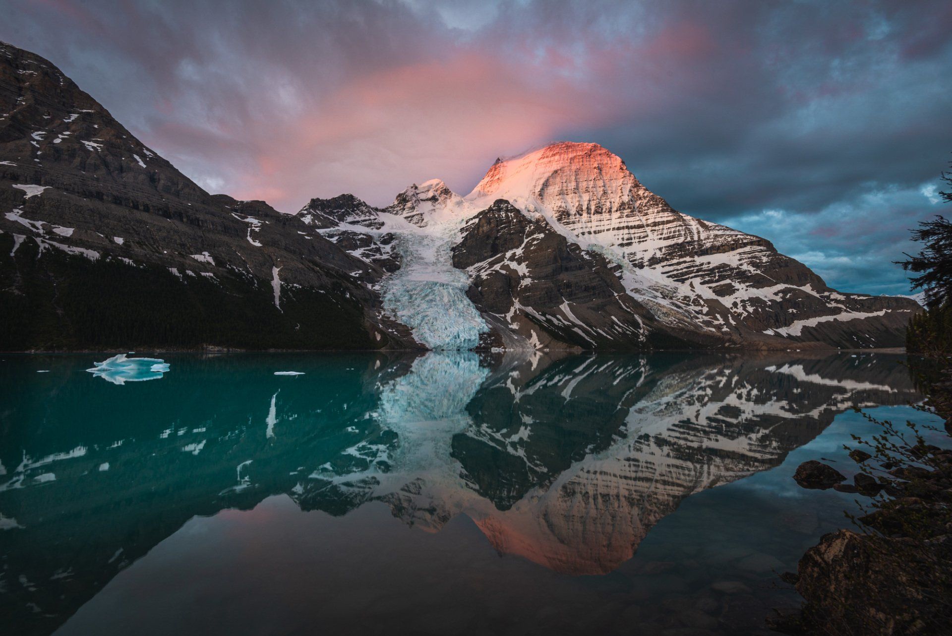 Sunrise on Berg lake, mt Robson park, BC, Canada. Turquoise lake and mountains touched with first rays of morning sun
