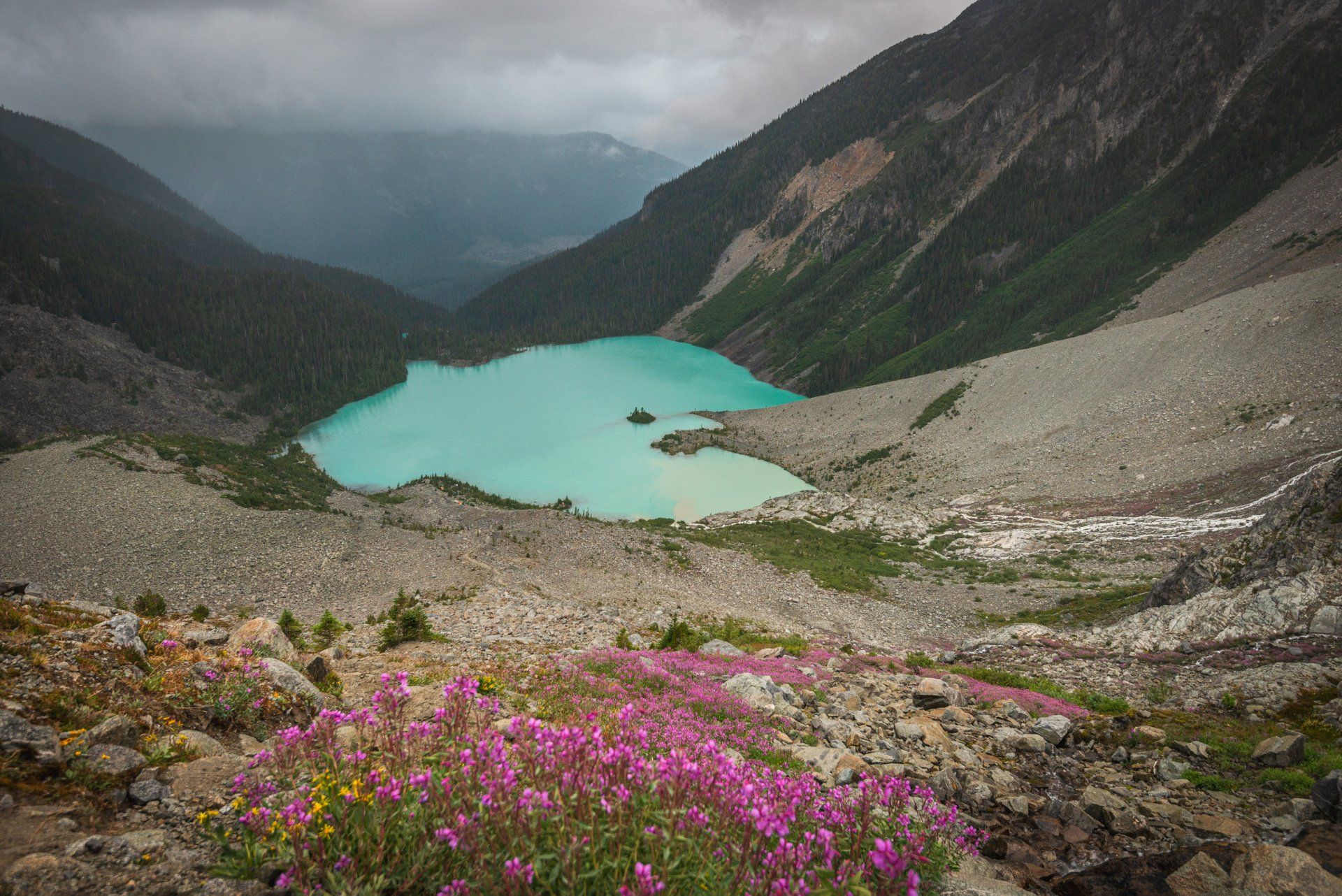 View of the upper Joffre lake from above with alpine flower meadows in the front, Joffre Lakes Provincial Park, BC, Canada