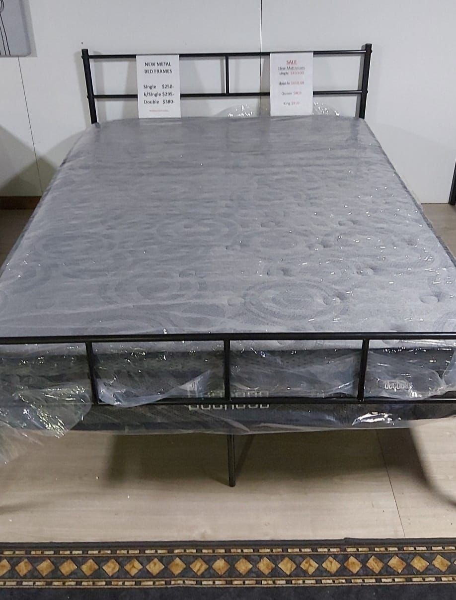 A Bed With a Mattress and a Metal Frame is Wrapped in Plastic — Anton's New & Used Furniture In Ciccone, NT