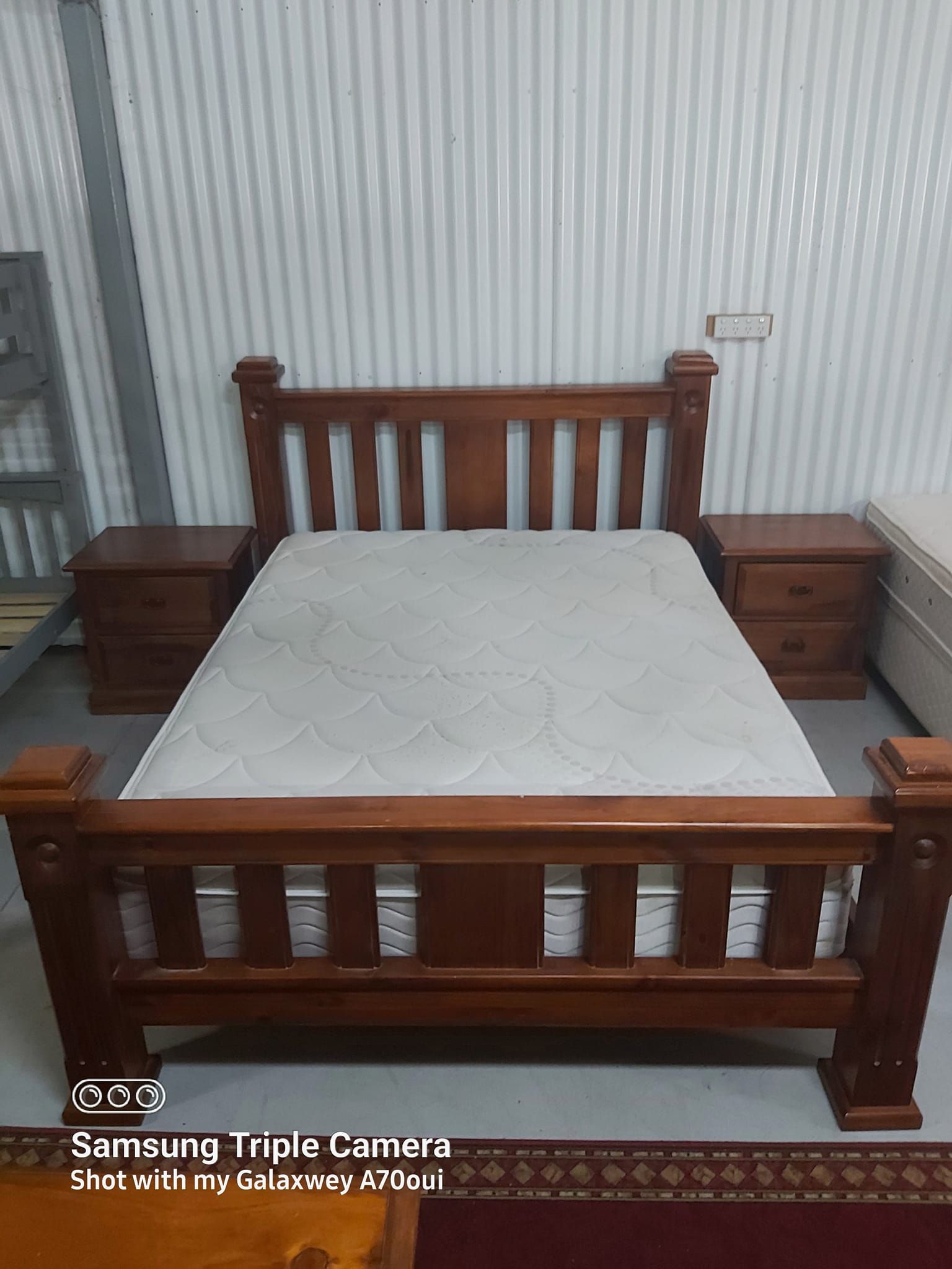 A Wooden Bed With a Mattress and Two Nightstands in a Room — Anton's New & Used Furniture In Ciccone, NT