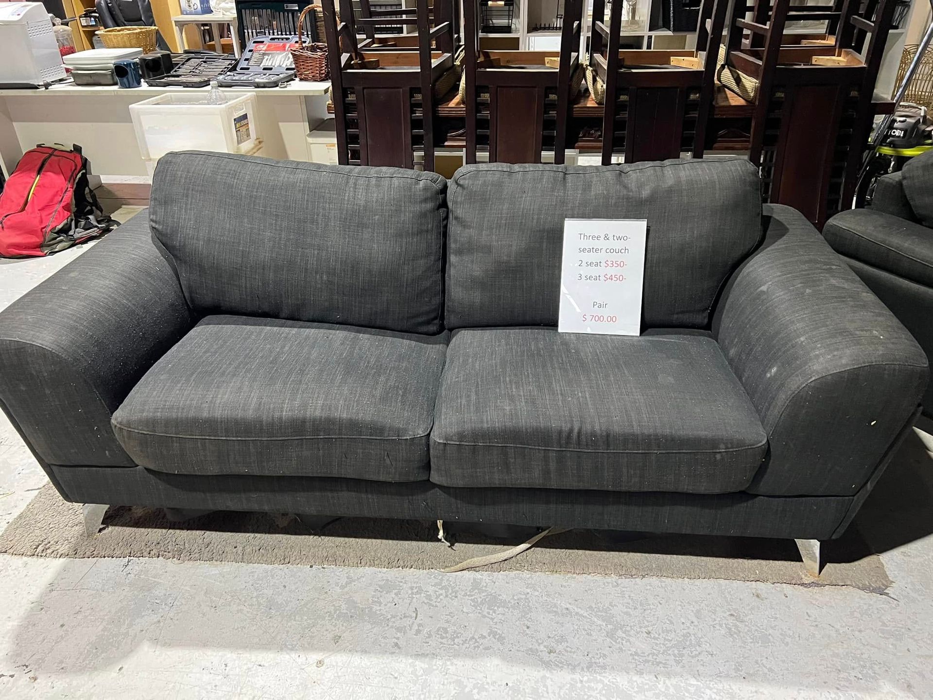 A Red Couch With Two Pillows is Sitting in a Room With Other Furniture — Anton's New & Used Furniture In Ciccone, NT