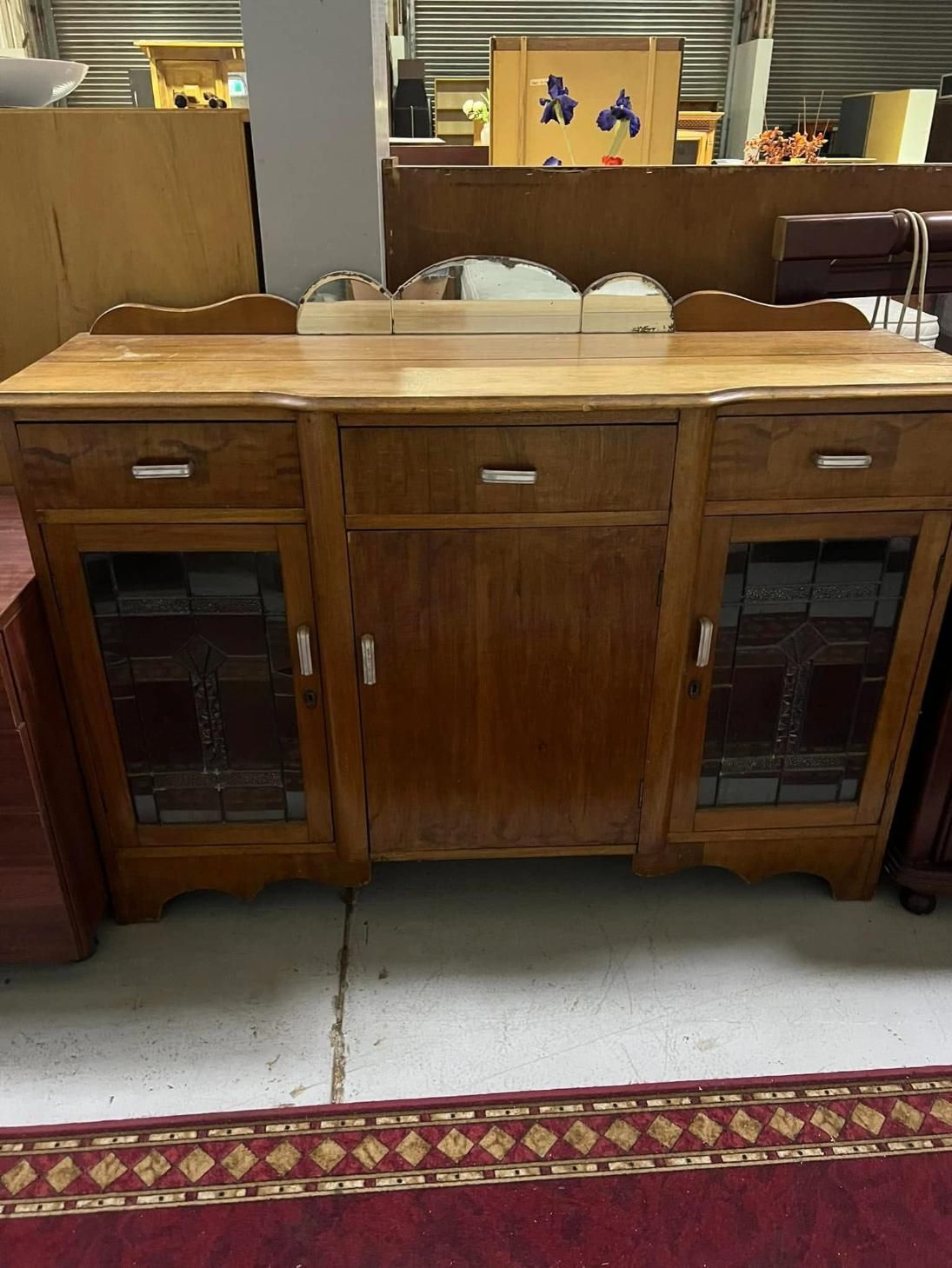 A Wooden Dresser With Drawers and a Mirror in a Room — Anton's New & Used Furniture In Ciccone, NT